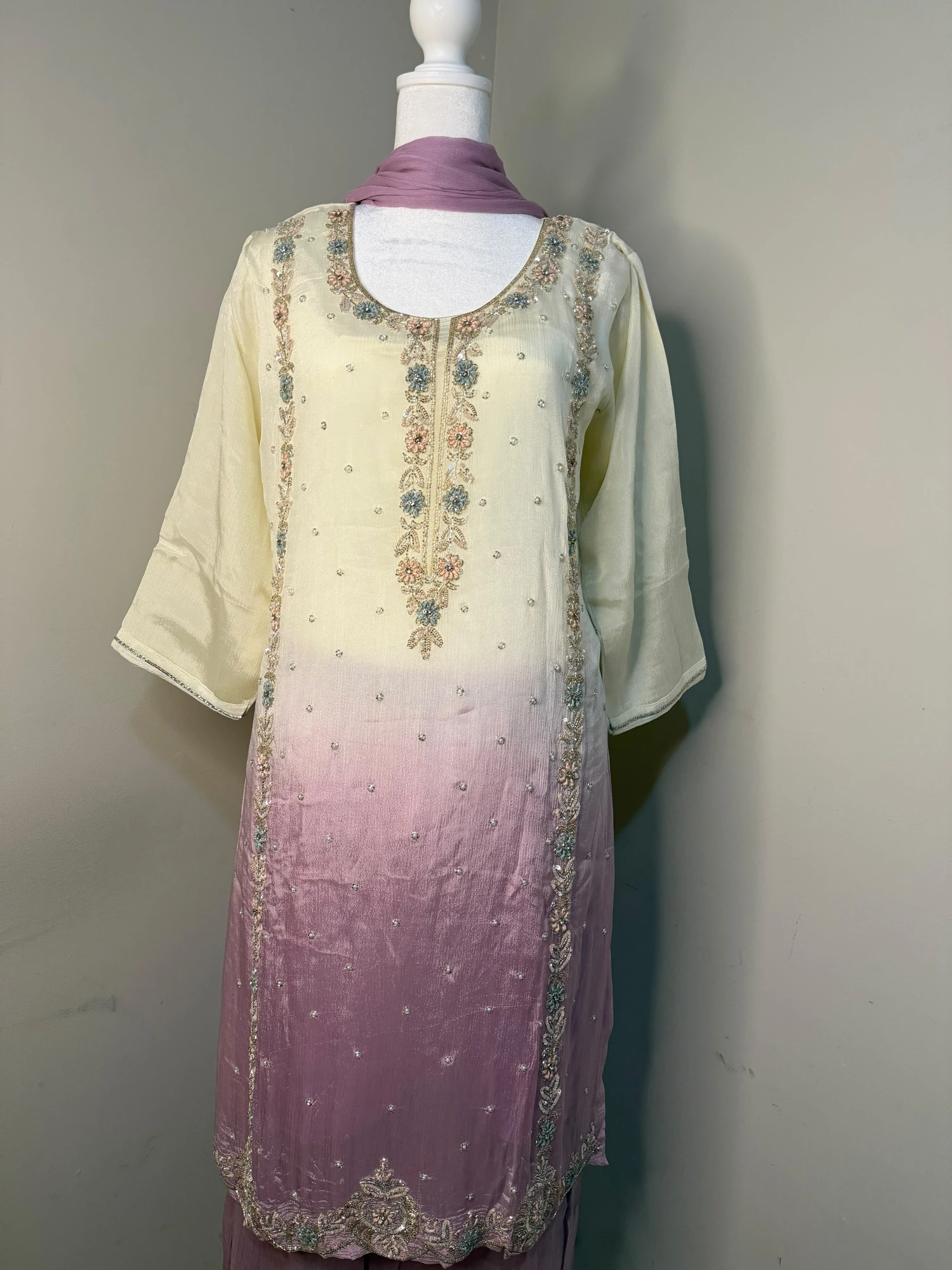 Front view of the cream-to-lilac kurta with floral embellishment and matching lilac trousers
