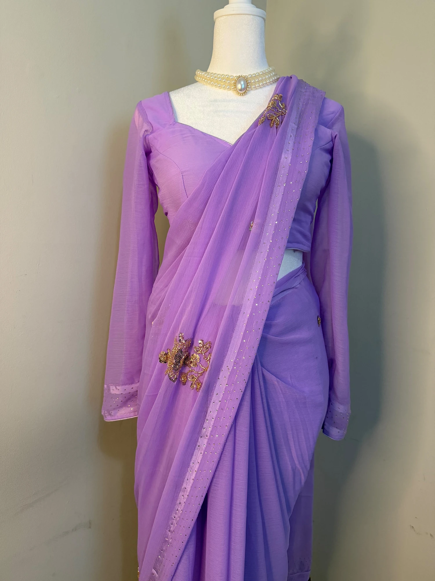 Front view of the lavender saree and long-sleeved blouse