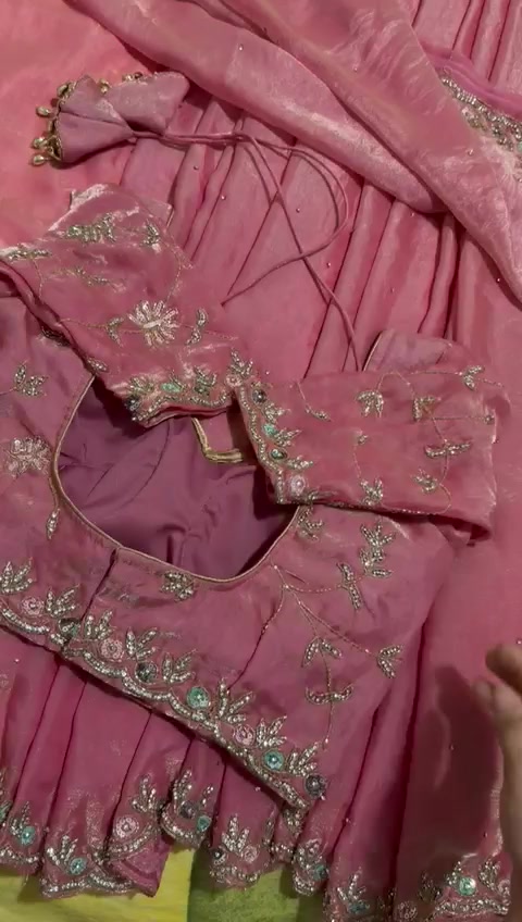 Detail from D’YORA’s original video of a rose-pink embellished outfit