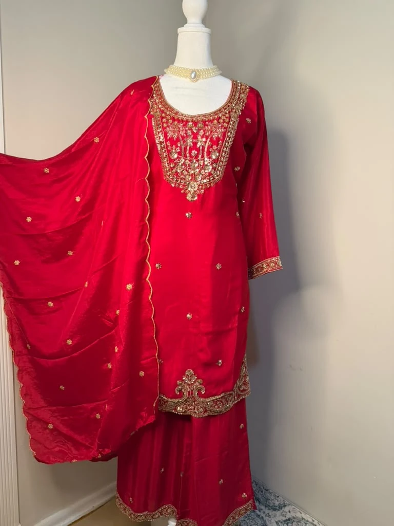 Front view of the red kurta outfit with gold-toned neckline and hem embellishment